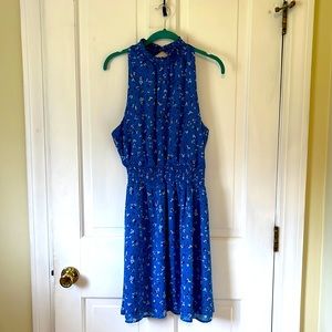 Above the knee flirty, sleeveless, high neck dress